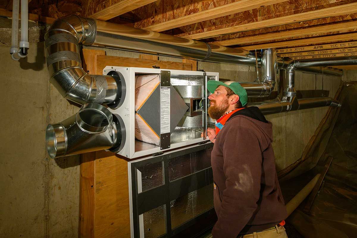 Building Analyst reviewing ducting in unconditioned basement